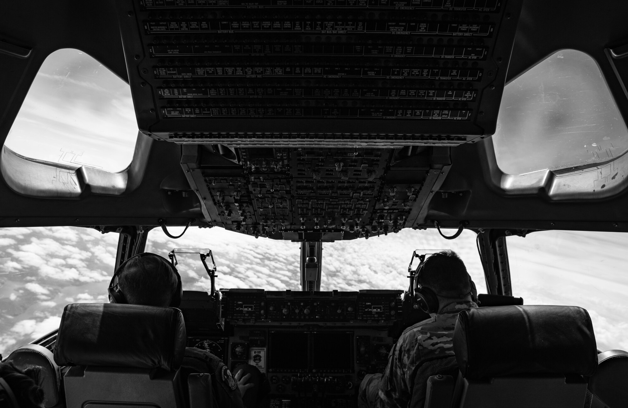 U.S. Air Force Capt. Dustin Weisner, left, 3rd Airlift Squadron pilot, and Capt. Thomas Heckman, right, 3rd AS pilot, fly a C-17 Globemaster III during a Leadership Central Delaware orientation flight near the U.S. East Coast, May 15, 2025. The LCD program, operated by the Central Delaware Chamber of Commerce, visits Dover AFB annually to gain better understanding of base operations and to build community ties with the Air Force. (U.S. Air Force photo by Staff Sgt. Marco A. Gomez)