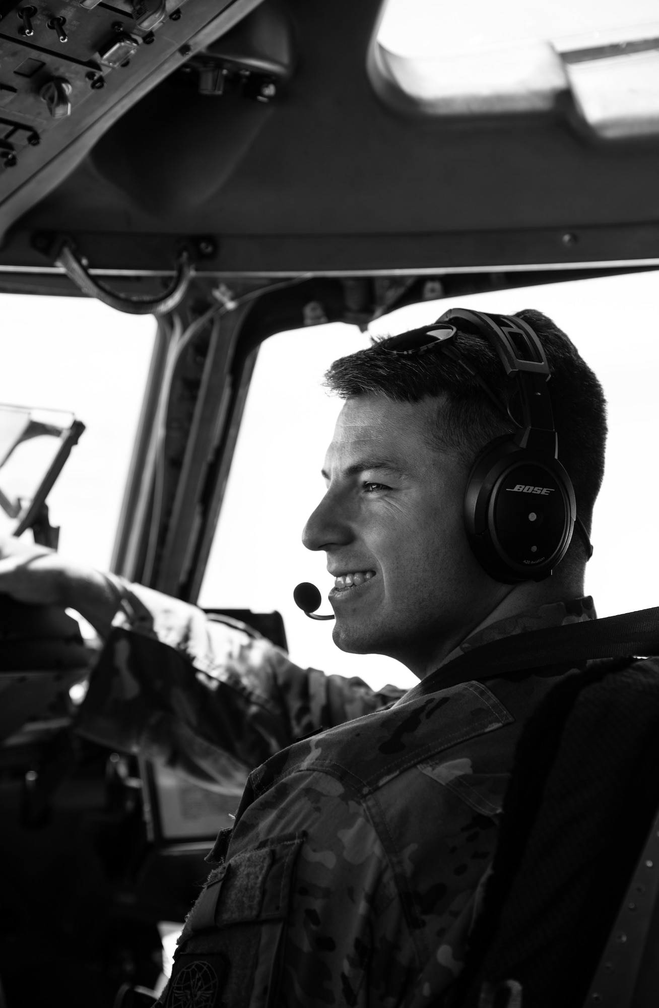 U.S. Air Force Capt. Thomas Heckman, 3rd Airlift Squadron pilot, smiles while flying a C-17 Globemaster III during a Leadership Central Delaware orientation flight near the U.S. East Coast, May 15, 2025. The LCD program, operated by the Central Delaware Chamber of Commerce, visits Dover AFB annually to gain better understanding of base operations and to build community ties with the Air Force. (U.S. Air Force photo by Staff Sgt. Marco A. Gomez)