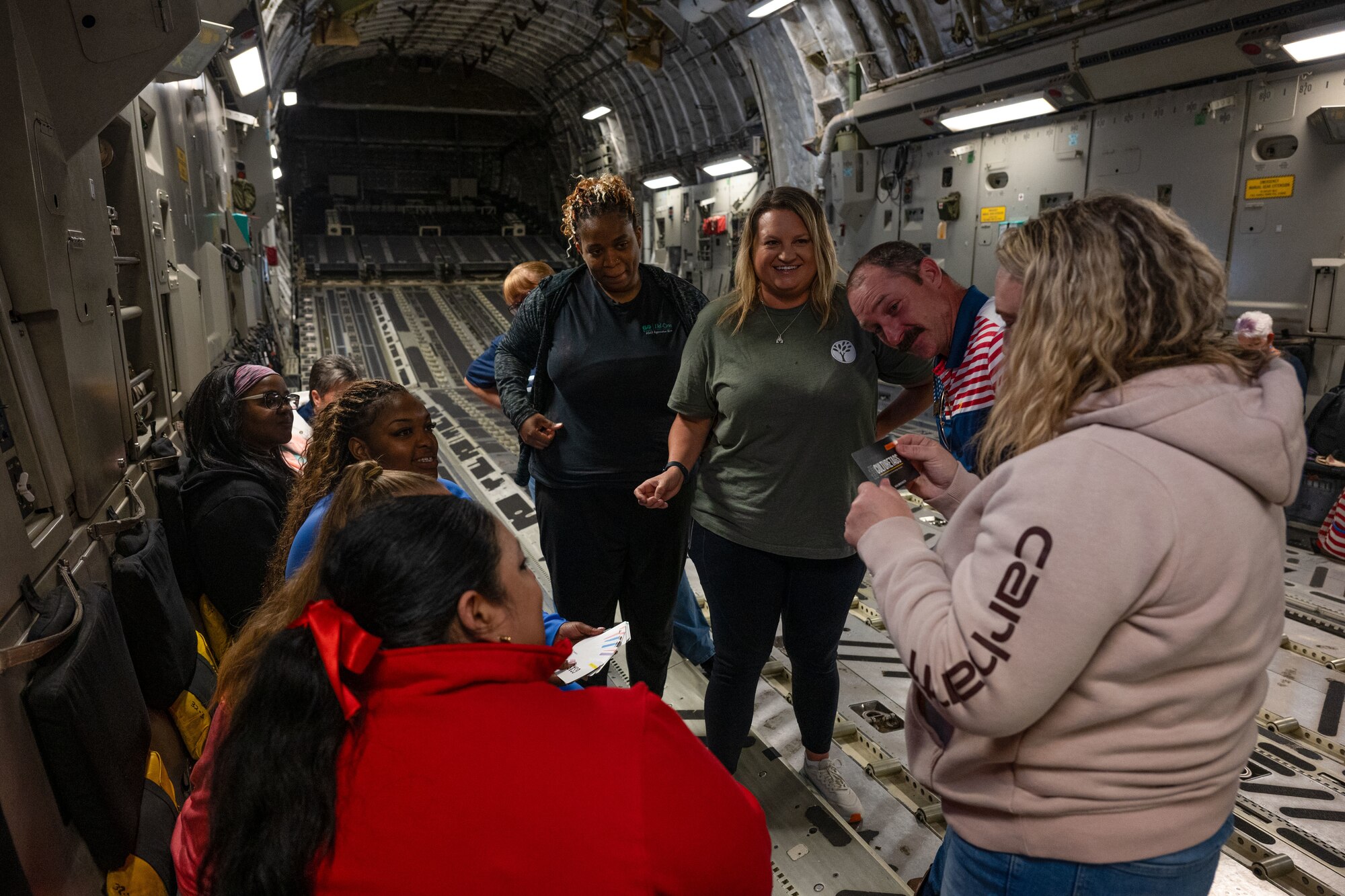 Leadership Central Delaware members play a game inside a C-17 Globemaster III during an orientation flight at Dover Air Force Base, Delaware, May 15, 2025. The LCD program, run by the Central Delaware Chamber of Commerce, visits Dover AFB annually to gain a better understanding of base operations and to build community ties with the Air Force. (U.S. Air Force photo by Senior Airman Trenten Walters)