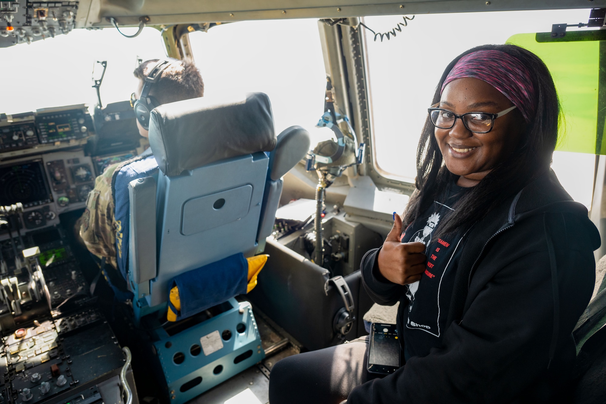 Saleana Watson, Leadership Central Delaware member, poses for a photo inside the flight deck of a C-17 Globemaster III during an orientation flight at Dover Air Force Base, Delaware, May 15, 2025. The LCD program, run by the Central Delaware Chamber of Commerce, visits Dover AFB annually to gain a better understanding of base operations and to build community ties with the Air Force. (U.S. Air Force photo by Senior Airman Trenten Walters)