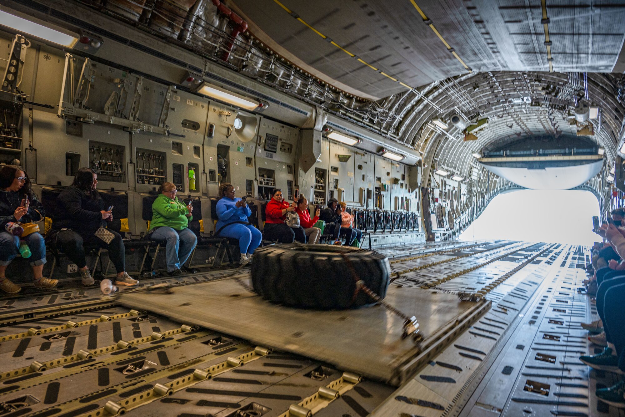 Leadership Central Delaware members watch a pallet slide by during a combat offload on a C-17 Globemaster III during an orientation flight at Dover Air Force Base, Delaware, May 15, 2025. The LCD program, run by the Central Delaware Chamber of Commerce, visits Dover AFB annually to gain a better understanding of base operations and to build community ties with the Air Force. (U.S. Air Force photo by Senior Airman Trenten Walters)