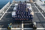 Crew members aboard U.S. Coast Guard Cutter Calhoun (WMSL 759) pose before preparing to offload pallets of illegal narcotics in Port Everglades, May 16, 2025. Calhoun’s crew offloaded more than 19,055 pounds of cocaine and marijuana valued at approximately $140.9 million in Port Everglades, May 16, 2025. (Coast Guard photo by Petty Officer 3rd Class Jessica Walker)