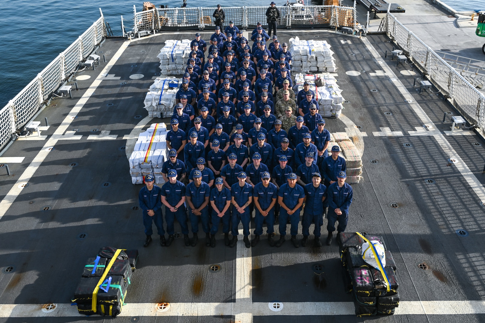 Crew members aboard U.S. Coast Guard Cutter Calhoun (WMSL 759) pose before preparing to offload pallets of illegal narcotics in Port Everglades, May 16, 2025. Calhoun’s crew offloaded more than 19,055 pounds of cocaine and marijuana valued at approximately $140.9 million in Port Everglades, May 16, 2025. (Coast Guard photo by Petty Officer 3rd Class Jessica Walker)