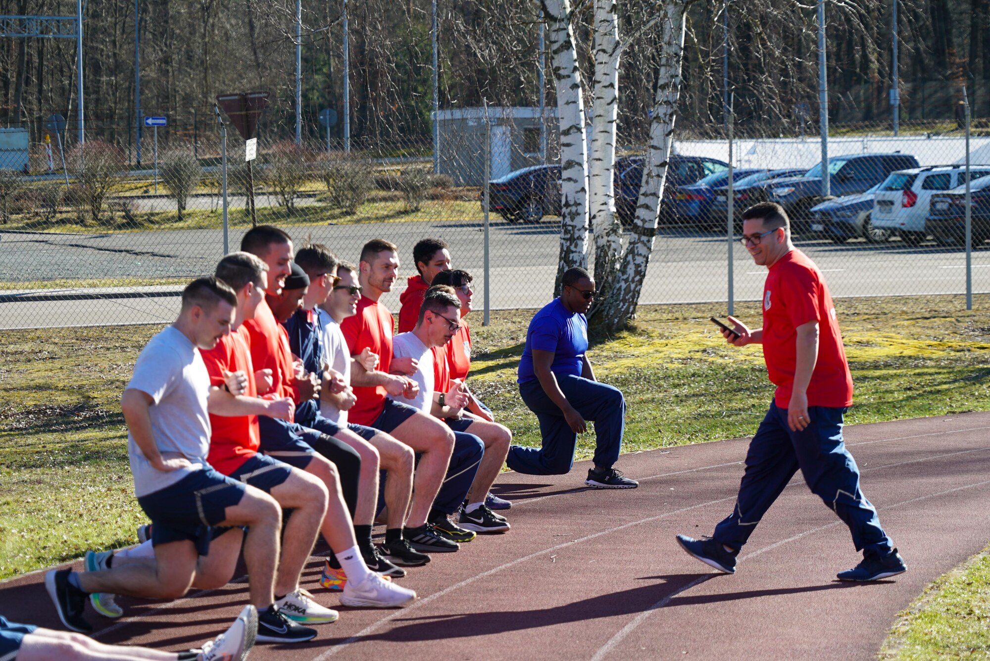 Students perform lunges during a group physical training session