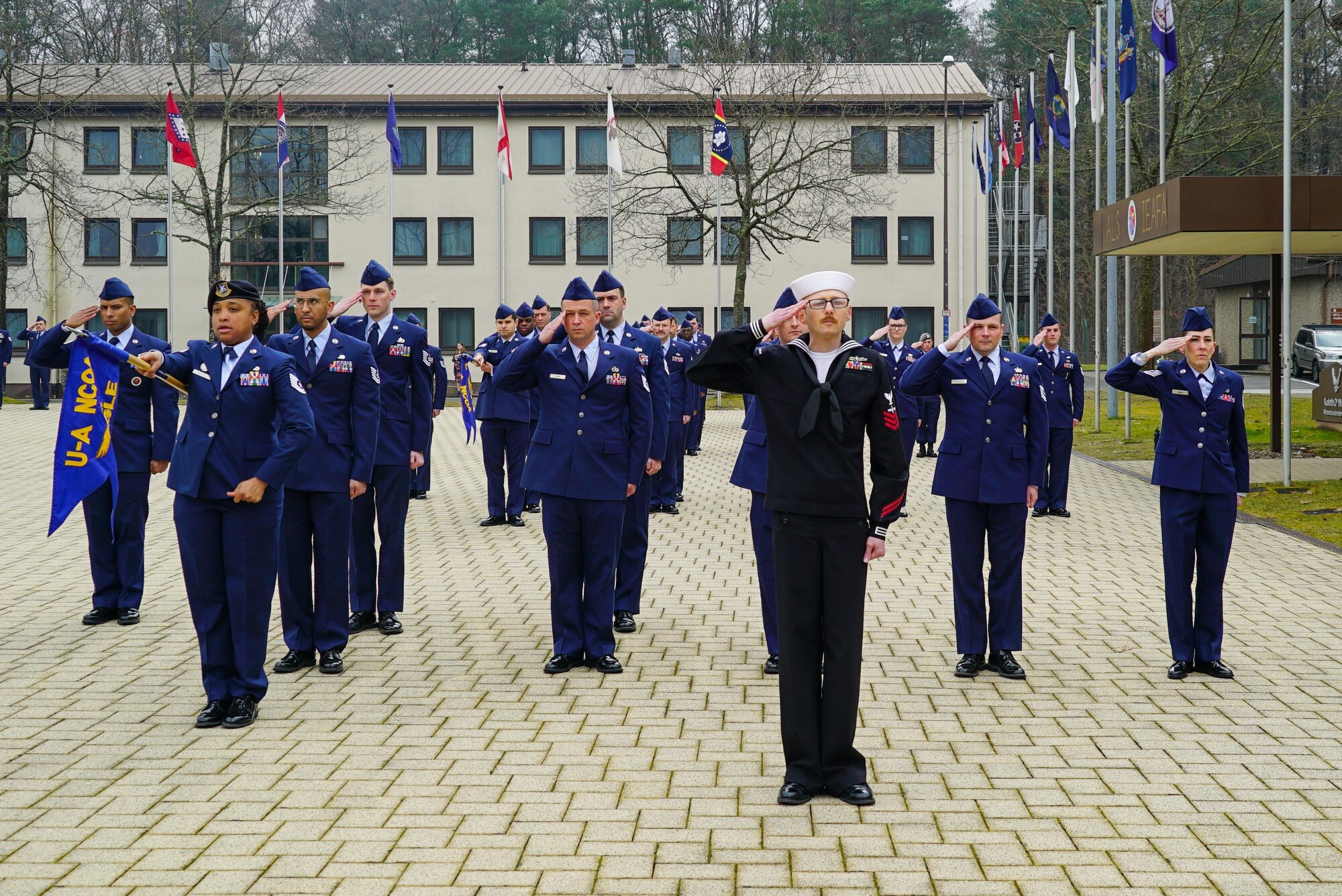 Students salute during a retreat ceremony