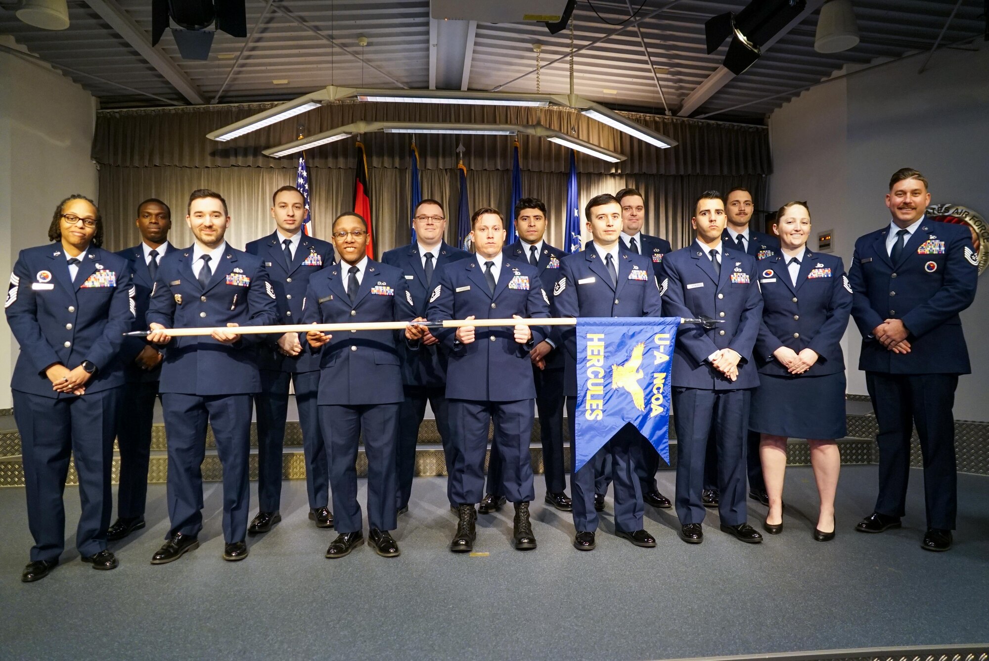 Graduates pose for a group photo during a graduation ceremony