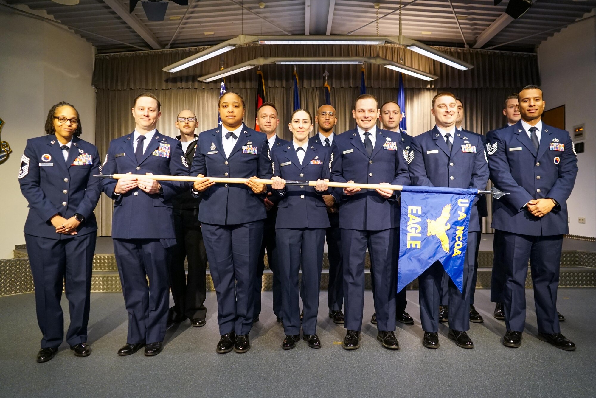 Graduates pose for a group photo during a graduation ceremony