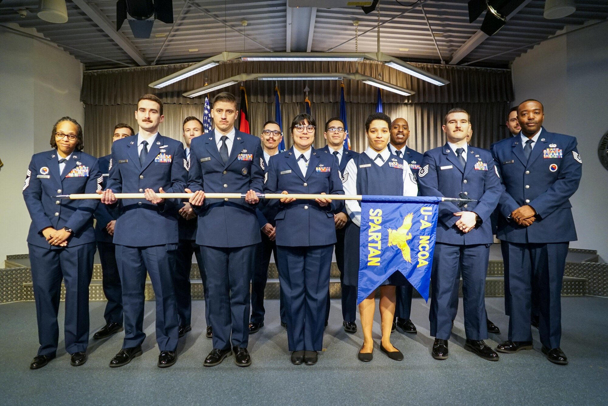 Graduates pose for a group photo during a graduation ceremony