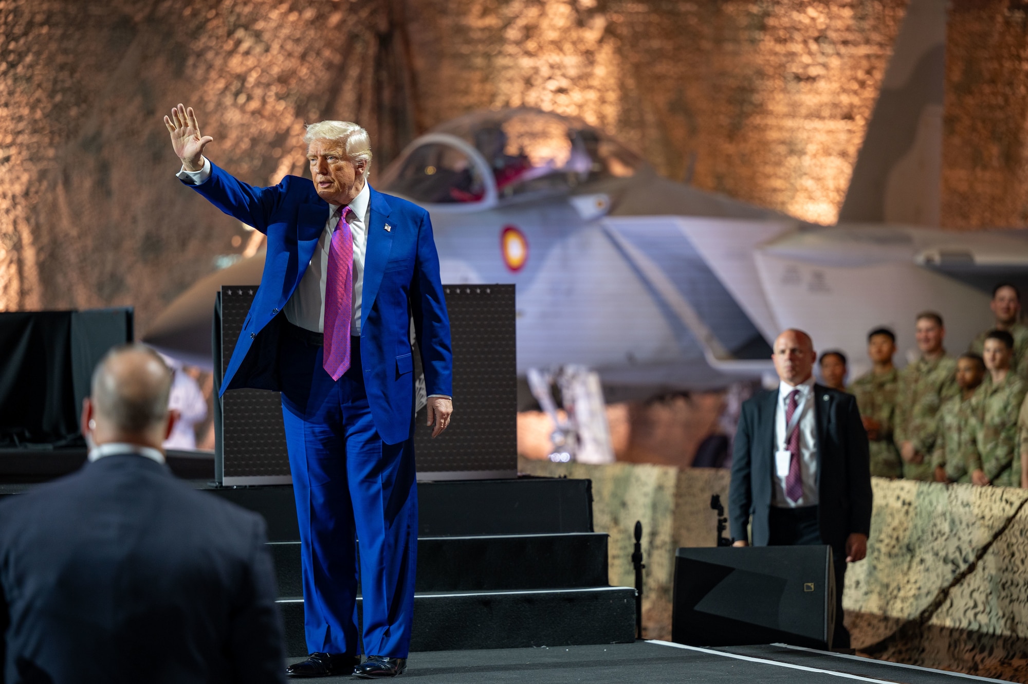 President Donald J. Trump waves to the crowd at the end of his address during a visit at Al Udeid Air Base, Qatar, May 15, 2025. Trump visited with troops during his trip to the Middle East, which included stops in Saudi Arabia, Qatar and the United Arab Emirates. (U.S. Air Force photo by Senior Airman Amanda Jett)