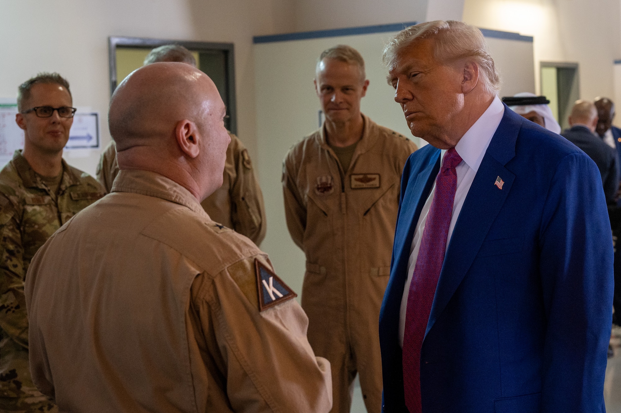 U.S. Air Force Brig. Gen. Richard Dickens, left, 379th Air Expeditionary Wing commander, greets President Donald J. Trump at Al Udeid Air Base, Qatar, May 15, 2025. Dickens briefed Trump on the 379th AEW’s critical role in the U.S. Central Command area of responsibility. (U.S. Air Force photo by 1st Lt. Trevor Wood)