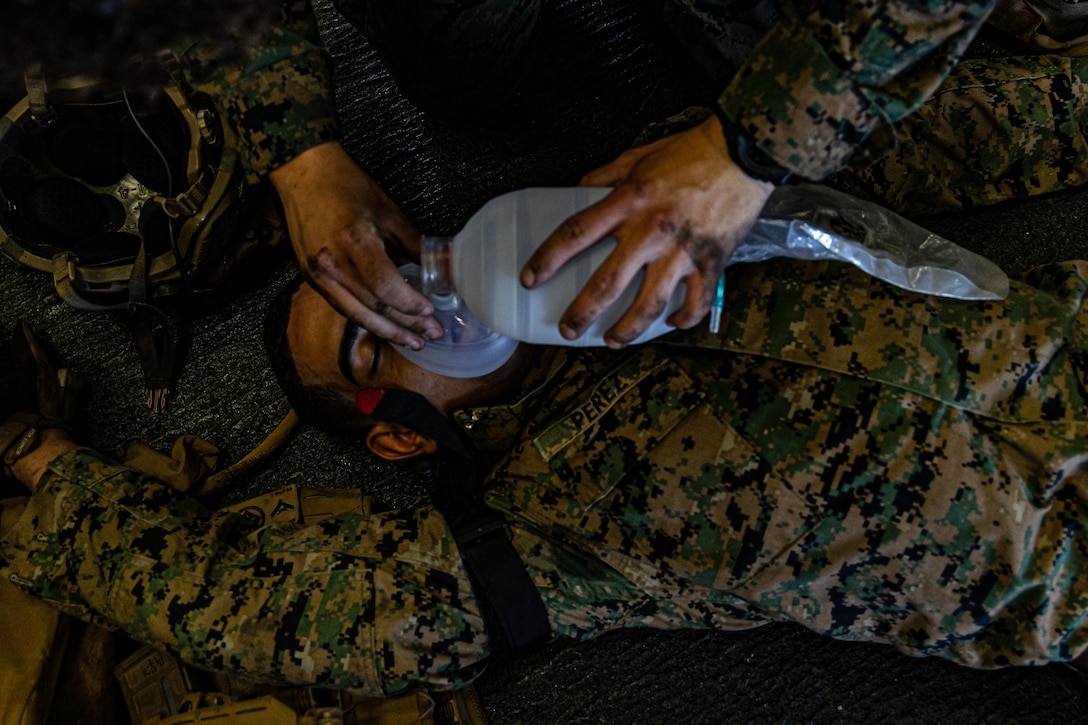 U.S. Marine Corps Lance Cpl. Angel Perez, a rifleman with Kilo Company, Battalion Landing Team, 3rd Battalion, 6th Marine Regiment, 22nd Marine Expeditionary Unit, acts as a simulated casualty for tactical combat casualty care training aboard the U.S. Navy Wasp-class amphibious assault ship USS Iwo Jima (LHD 7), in support of Iwo Jima Amphibious Ready Group Marine Expeditionary Unit Exercise (ARGMEUEX) while underway in the Atlantic Ocean, May 14, 2025. During ARGMEUX, the 22nd MEU, aboard IWO ARG shipping, conducts training in support of various mission essential tasks that enhance operational readiness and lethality as a unified IWOARG/22 MEU team. (U.S. Marine Corps photo by Cpl. Emily Hazelbaker)