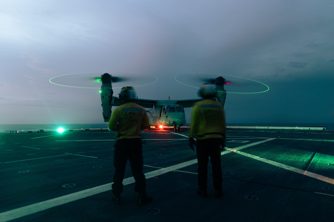 U.S. Navy Seamen Jocar Vinas, right, and , Petty Officer 3rd Class Darrell Agustin, both aviation boatswainmate handlers with the San Antonio-class amphibious transport dock ship, USS San Antonio (LPD 17), Iwo Jima Amphibious Ready Group (IWOARG), observe a U.S. Marine Corps MV-22B Osprey with Marine Medium Tiltrotor Squadron 263 (Reinforced), 22nd Marine Expeditionary Unit, during flight operations as part of ARGMEUEX, aboard the San Antonio, IWOARG, while underway in the Atlantic Ocean, May 15, 2025. During ARGMEUX, the 22nd MEU, aboard IWOARG shipping, conducts training in support of various mission essential tasks that enhance operational readiness and lethality as a unified IWOARG/22 MEU team. (U.S. Marine Corps photo by Cpl. Maurion Moore)
