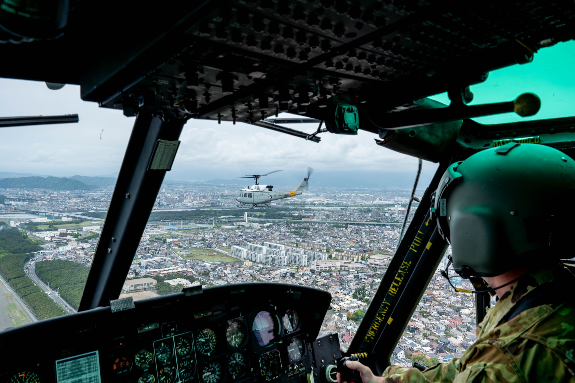 inside a flying helicopter with a view of a city