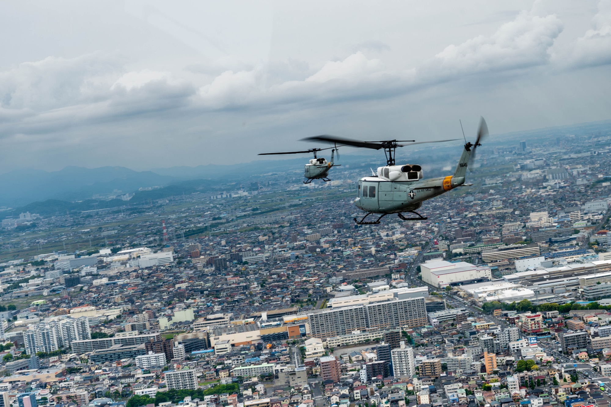 two helicopters over a city