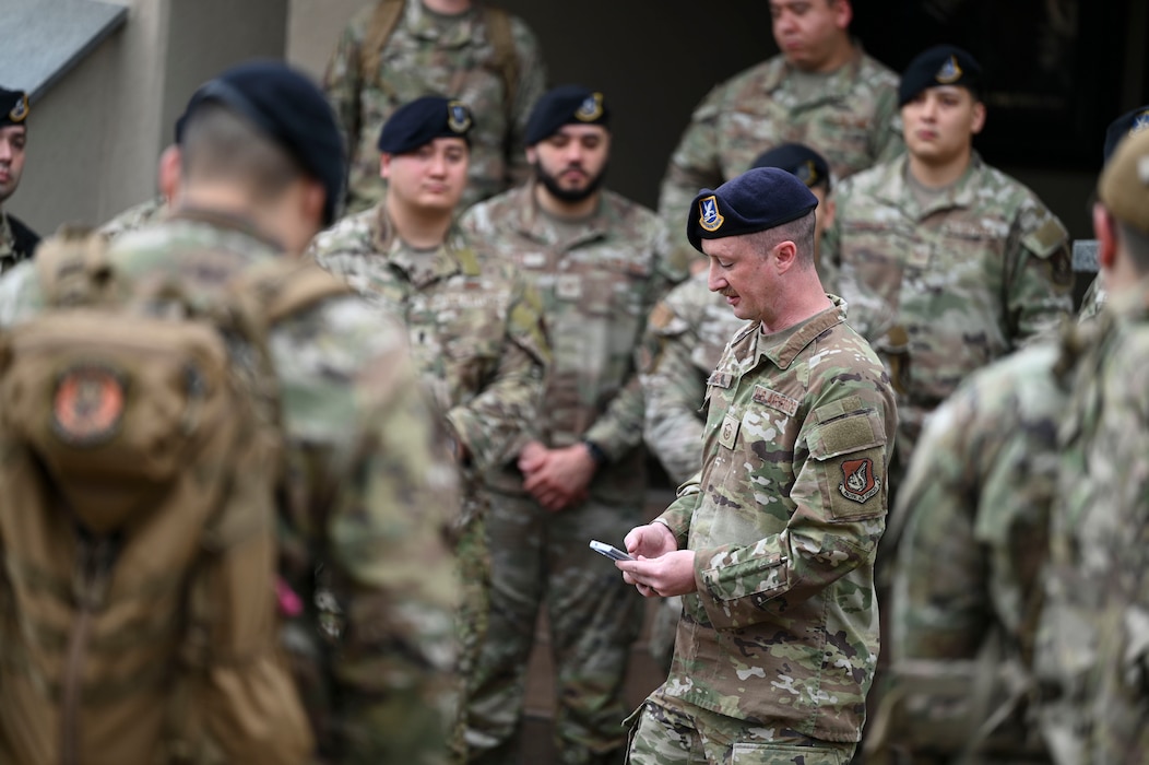Master Sgt. Christopher Pate, 8th Security Forces Squadron defender, lists the names of defenders who perished during combat during the Police Week opening ceremony at Kunsan Air Base, Republic of Korea, May 16, 2025. After the ceremony, defenders participated in various events such as a ruck, and a “Battle of the Pack” competition.
