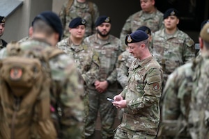 Master Sgt. Christopher Pate, 8th Security Forces Squadron defender, lists the names of defenders who perished during combat during the Police Week opening ceremony at Kunsan Air Base, Republic of Korea, May 16, 2025. After the ceremony, defenders participated in various events such as a ruck, and a “Battle of the Pack” competition.