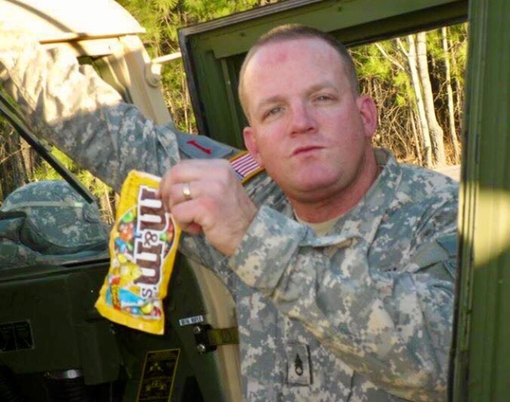 Sgt. 1st Class John Beale poses with his favorite candy while seating in a Georgia Army National Guard armored humvee.