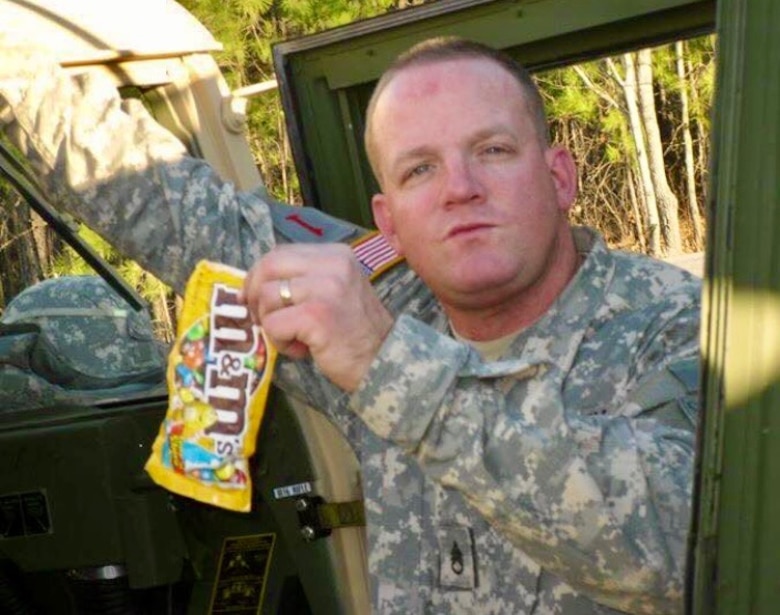 Sgt. 1st Class John Beale poses with his favorite candy while seating in a Georgia Army National Guard armored humvee.