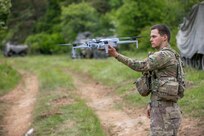 U.S. Army Spc. Anton Lane, a combat medic with specialized drone training, assigned to 5-7 Cavalry, 1st Armored Brigade Combat Team, 3rd Infantry Division prepares to deploy a Skydio X10E4TT drone by hand during exercise Combined Resolve 25-2 at Hohenfels, Germany on May 17, 2025.