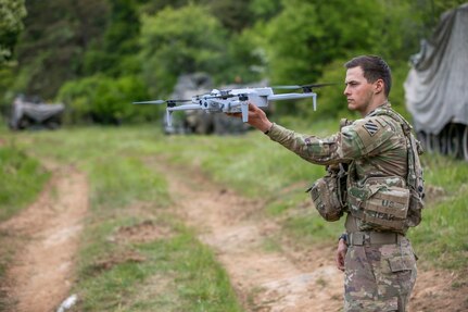 U.S. Army Spc. Anton Lane, a combat medic with specialized drone training, assigned to 5-7 Cavalry, 1st Armored Brigade Combat Team, 3rd Infantry Division prepares to deploy a Skydio X10E4TT drone by hand during exercise Combined Resolve 25-2 at Hohenfels, Germany on May 17, 2025.