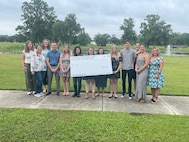 people holding a big check
