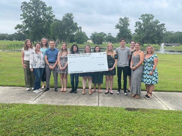 people holding a big check