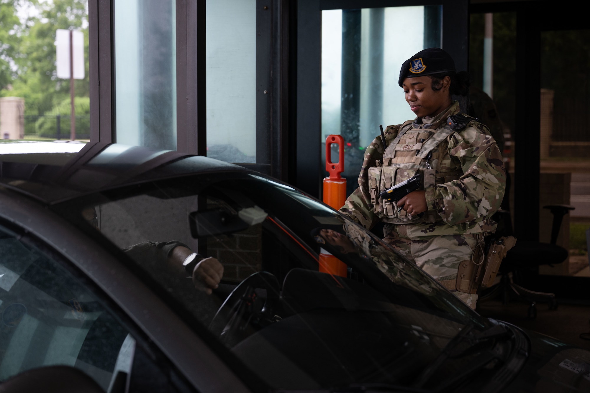U.S. Airman 1st Class Lemaya Veale, 436th Security Forces Squadron response force member, checks common access cards at Dover Air Force Base, Delaware, May 14, 2025. The motto “defensor fortis” means “strong defender,” the official motto of SF, defining the concept of strength in adversity, taught to members of SF. (U.S. Air Force photo by Airman 1st Class Liberty Matthews)