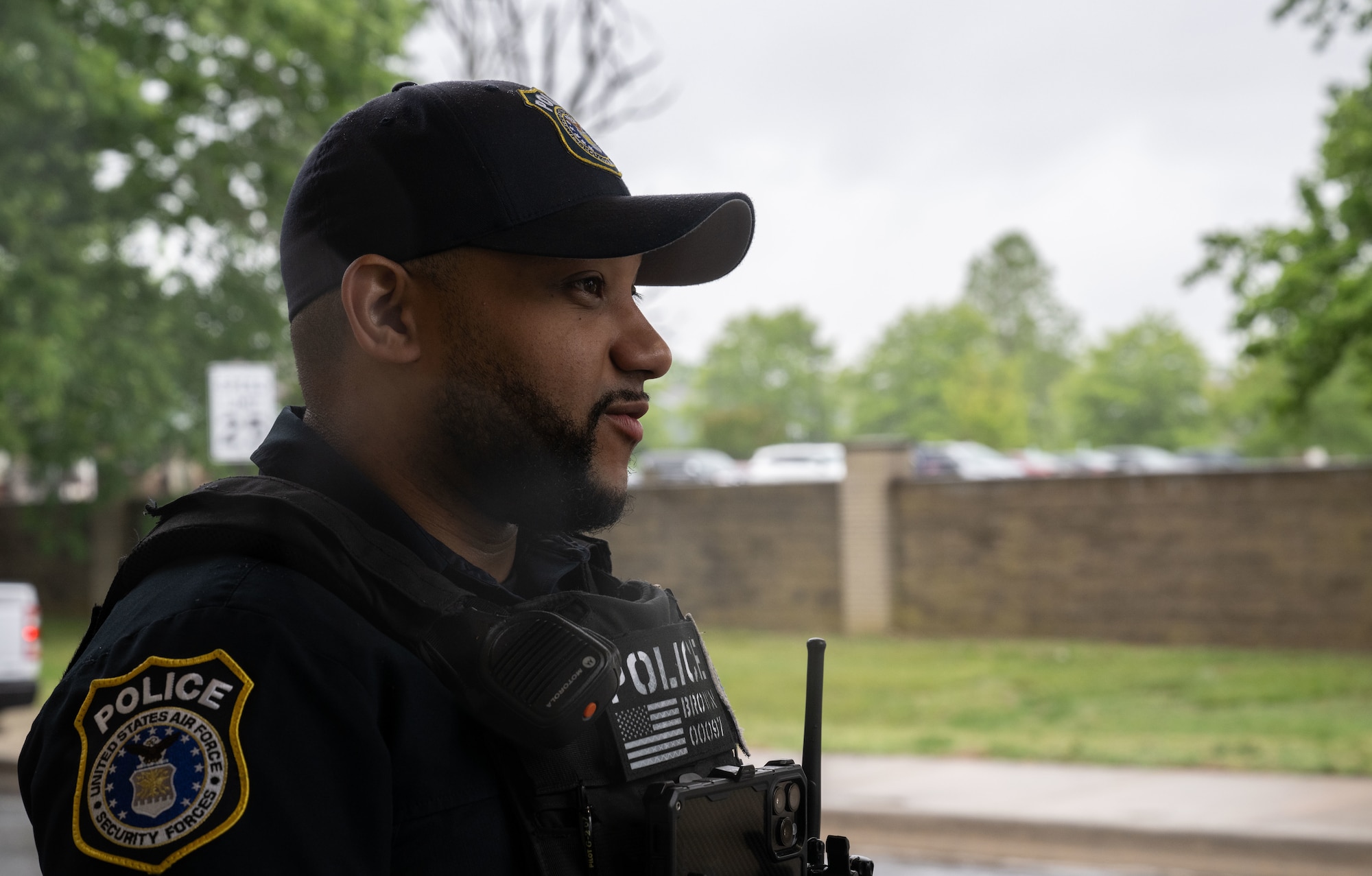 Joshua Brown, Department of the Air Force Police officer, talks with his partner at the housing gate on Dover Air Force Base, Delaware, May 14, 2025. The motto “defensor fortis” means “strong defender,” the official motto of SF, defining the concept of strength in adversity, taught to members of SF. (U.S. Air Force photo by Airman 1st Class Liberty Matthews)