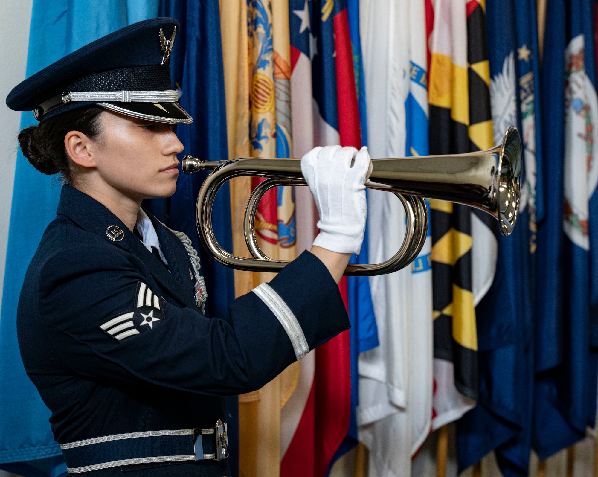 woman in blues holding bugle