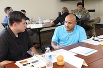 Two Soldiers work together to complete a training exercise during the three-day Tier 2 Ask Care Escort Suicide Prevention liaison training at Paul G. Schulstad Army Reserve Center in Arlington Heights, Illinois.