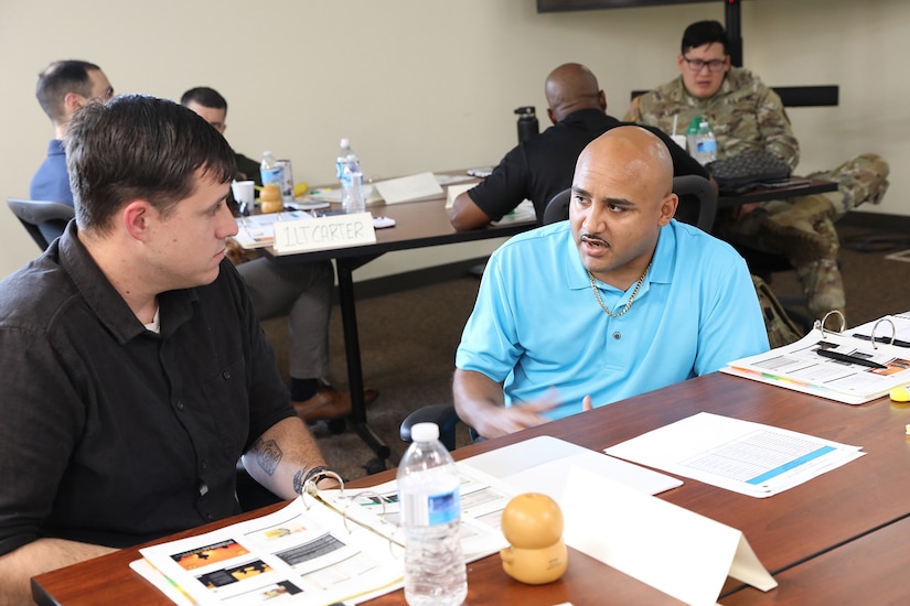 Two Soldiers work together to complete a training exercise during the three-day Tier 2 Ask Care Escort Suicide Prevention liaison training at Paul G. Schulstad Army Reserve Center in Arlington Heights, Illinois.