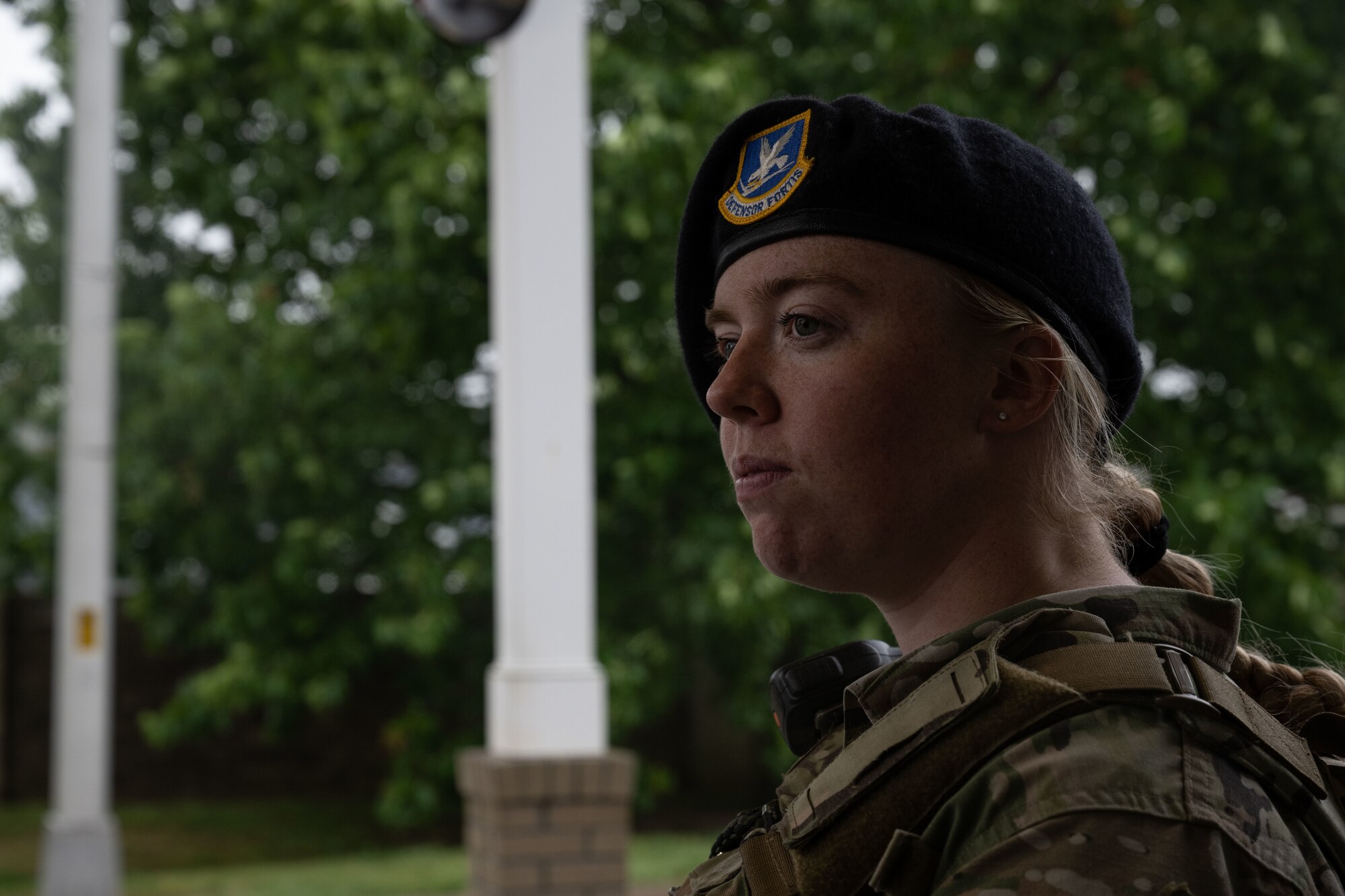 U.S. Airman 1st Class Miranda Graham, 436th Security Forces Squadron response force member, listens to her partner at the housing gate on Dover Air Force Base, Delaware, May 14, 2025. The motto “defensor fortis” means “strong defender,” the official motto of SF, defining the concept of strength in adversity, taught to members of SF. (U.S. Air Force photo by Airman 1st Class Liberty Matthews)
