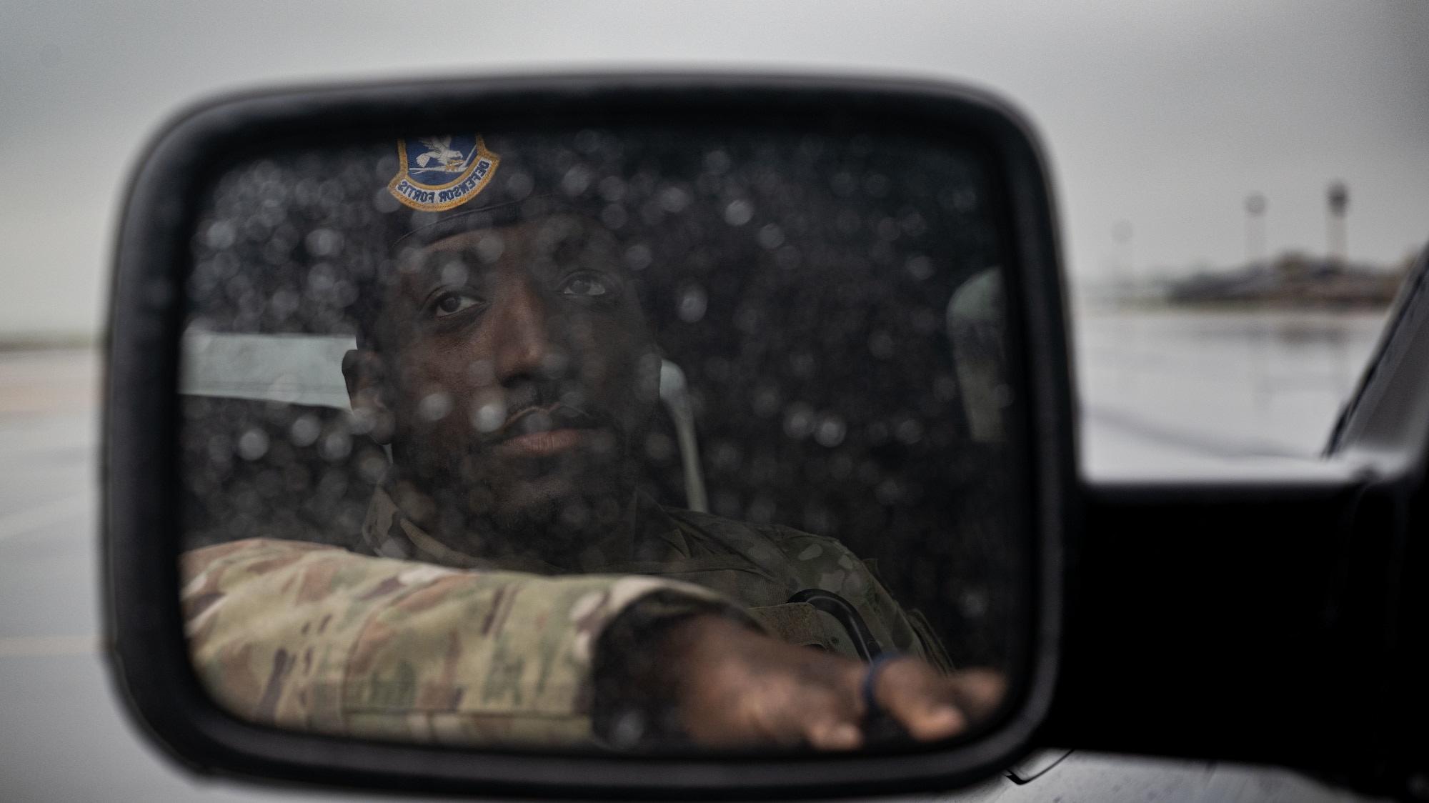 U.S. Airman 1st Class Sheamar Smith, 436th Security Forces Squadron response force member, watches over C-5M Super Galaxy operations in a patrol truck at Dover Air Force Base, Delaware, May 14, 2025. The motto “defensor fortis” means “strong defender,” the official motto of SF, defining the concept of strength in adversity, taught to members of SF. (U.S. Air Force photo by Airman 1st Class Liberty Matthews)