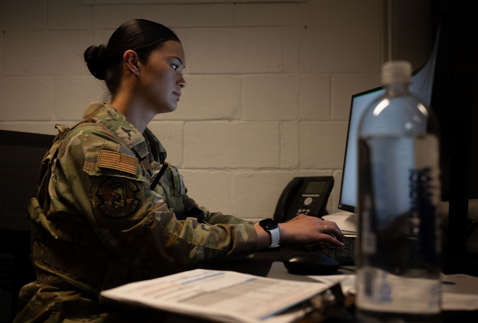 U.S. Air Force Staff Sgt. Gianni Perreira, 436th Security Forces Squadron base defense operations center member, types on her computer at Dover Air Force Base, Delaware, May 14, 2025. The motto “defensor fortis” means “strong defender,” the official motto of SF, defining the concept of strength in adversity, taught to members of SF. (U.S. Air Force photo by Airman 1st Class Liberty Matthews)