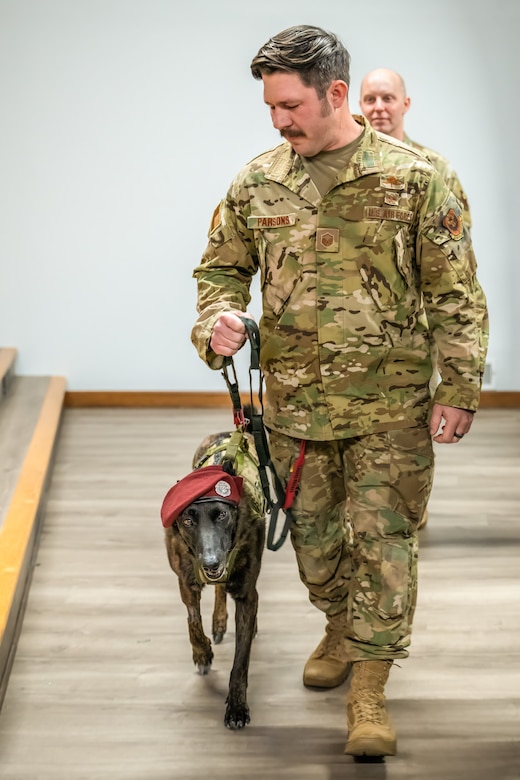 Callie, the only certified search-and-rescue dog in the Department of Defense, arrives with her handler, Master Sgt. Rudy Parsons, for her retirement ceremony at the Kentucky Air National Guard Base in Louisville, Ky., Jan. 24, 2025.