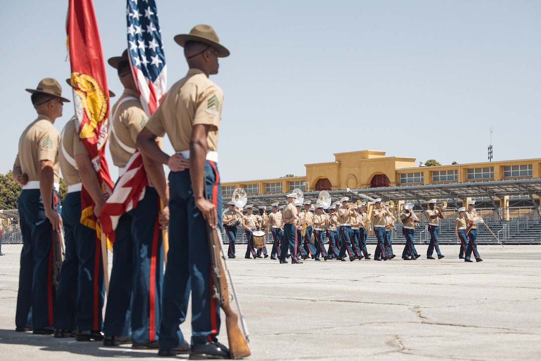 US Marine color guard stands at parade rest while the band performs during the MCRD San Diego change of command