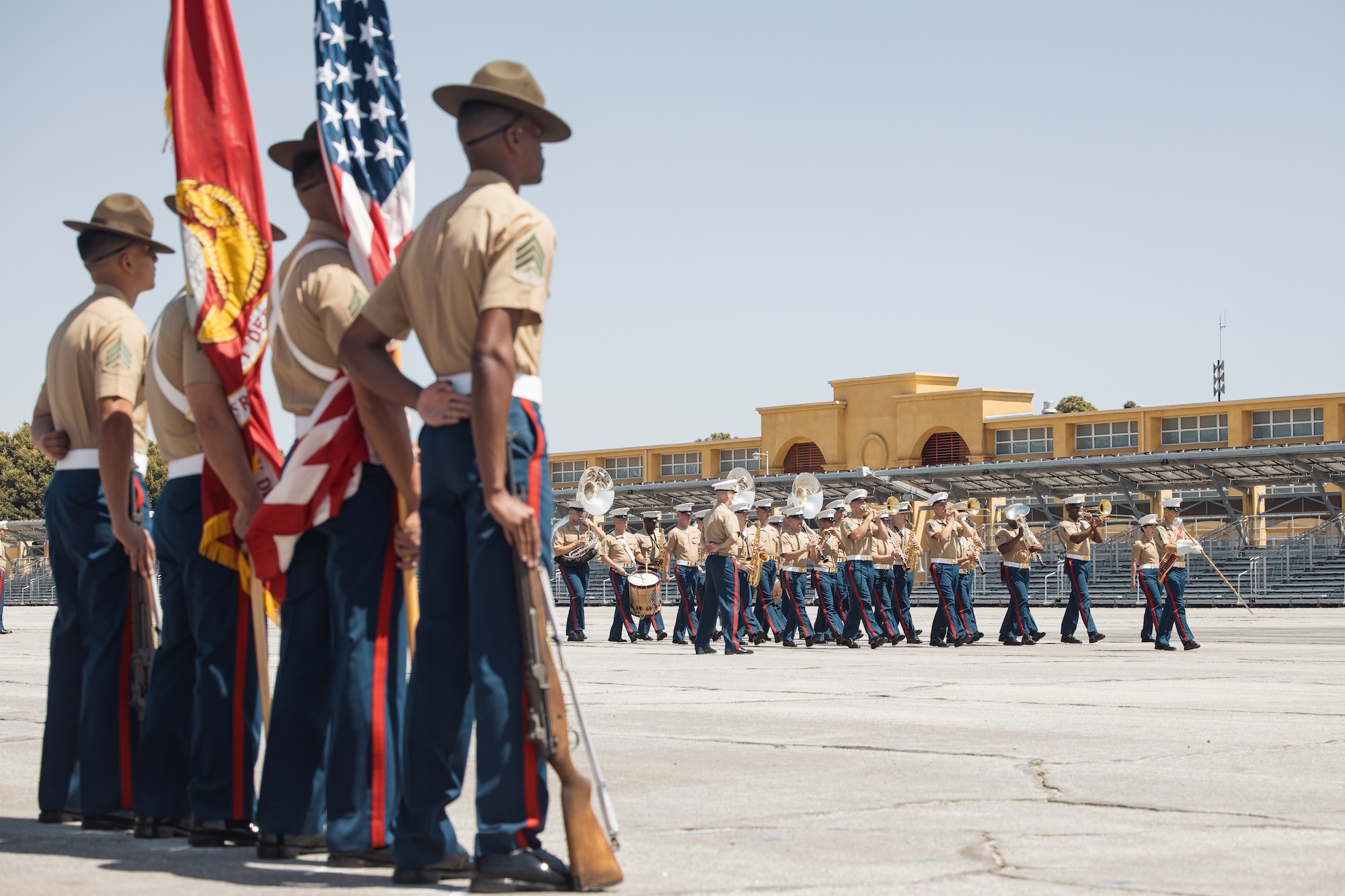 US Marine color guard stands at parade rest while the band performs during the MCRD San Diego change of command