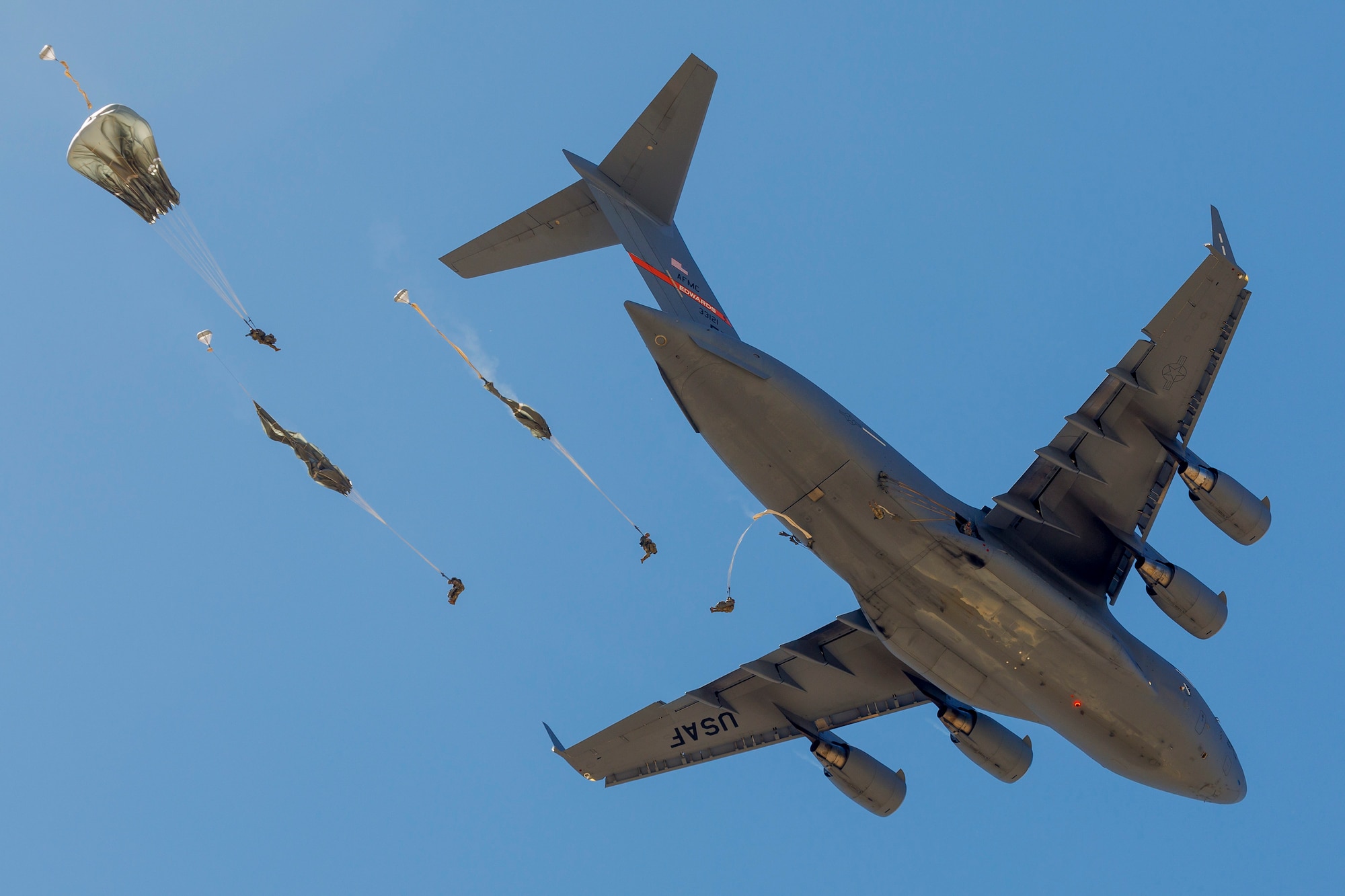 Army Civil Affairs Soldiers from the 426th Civil Affairs Battalion, 358th Civil Affairs Brigade, jump out of a C-17 assigned to the 418th Flight Test Squadron during a joint training exercise above Edwards Air Force Base, California, April 11. (Air Force photo by CJ Raterman)
