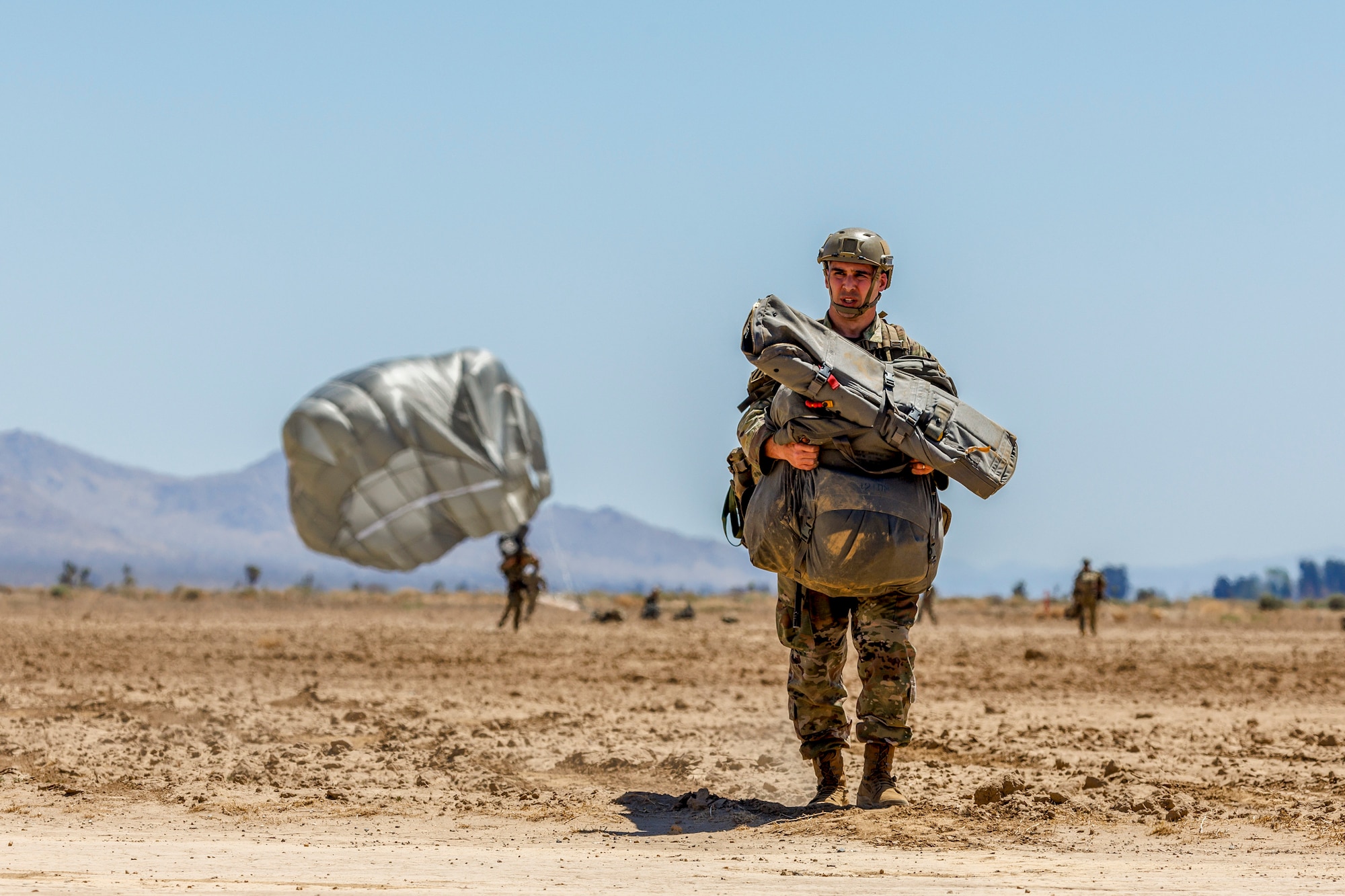 A Soldier from the 426th Civil Affairs Battalion, 358th Civil Affairs Brigade, walks off the drop zone following a static line jump at Edwards Air Force Base, California, April 11. (Air Force photo by CJ Raterman)