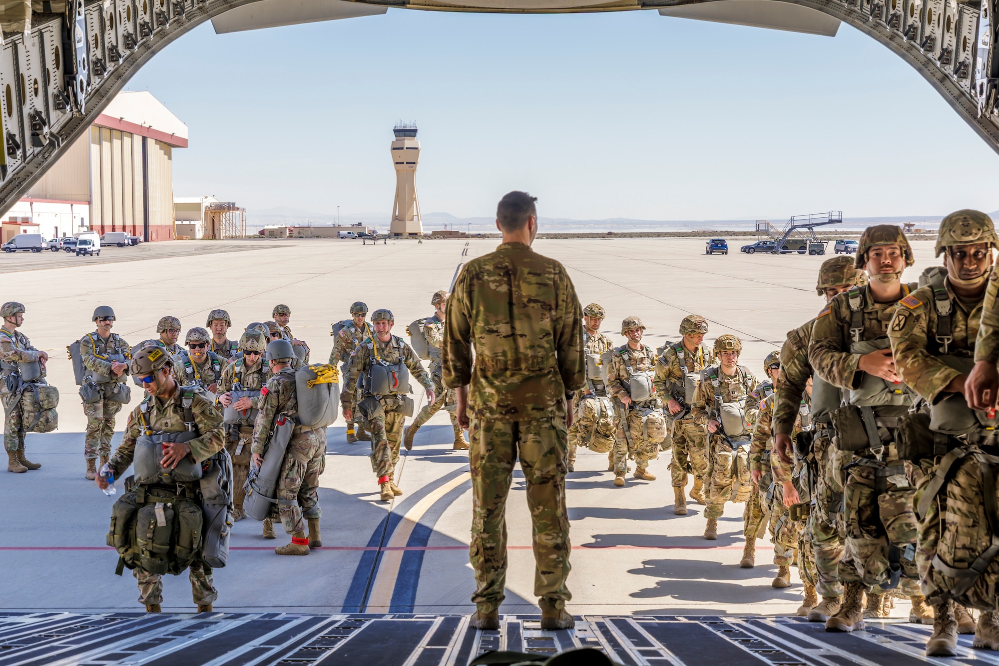 Tech. Sgt. Tanner Sullivan, 418th Flight Test Squadron C-17 loadmaster, looks onward as Army Civil Affairs paratroopers board a C-17 at Edwards Air Force Base, California, April 11. (Air Force photo by James West)