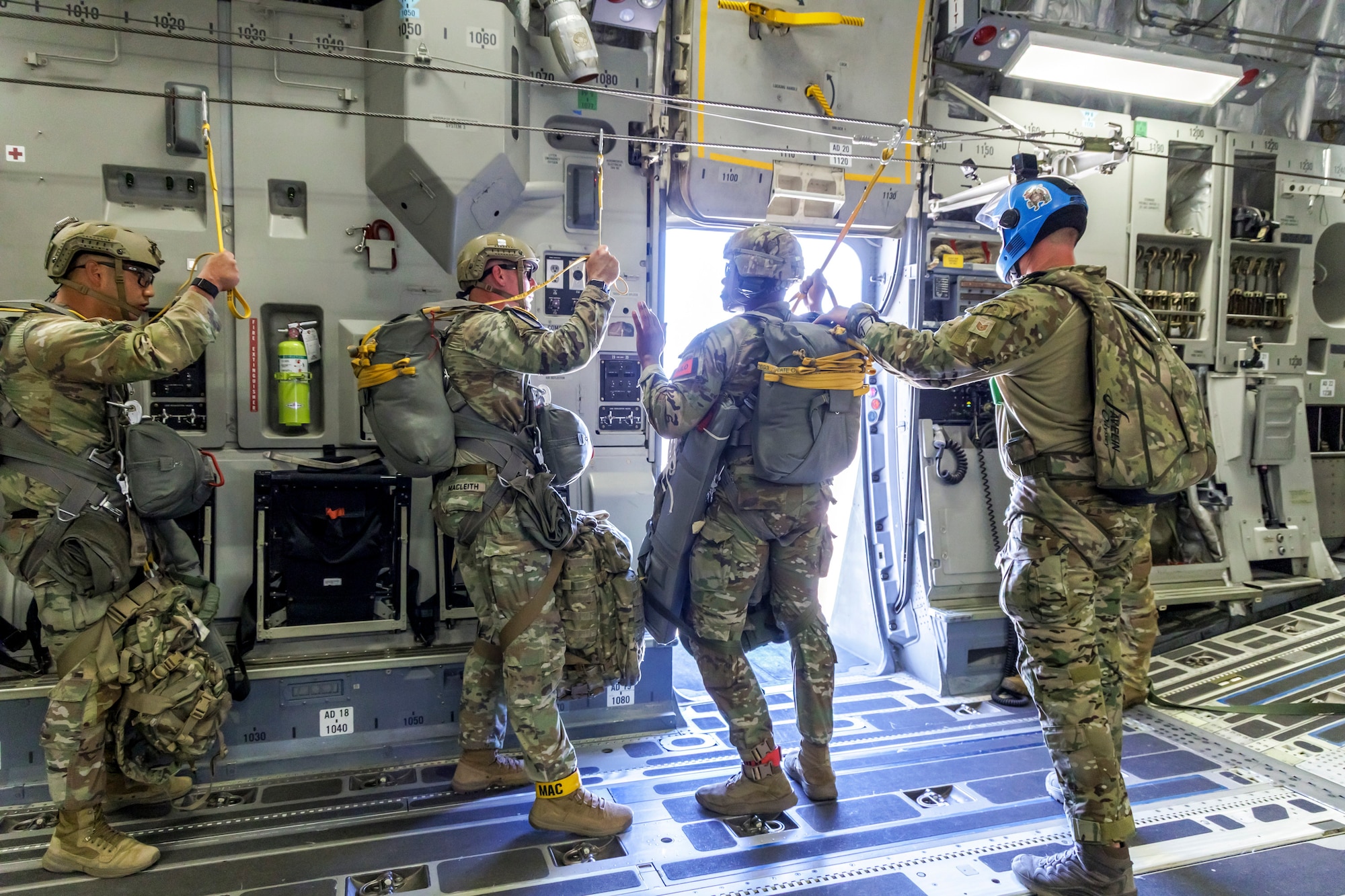 Tech. Sgt. Robert Gregory, 412th OSS SERE/TPP superintendent, prepares Army Civil Affairs troopers for a static line jump aboard a C-17 above Edwards Air Force Base, California, April 11. (Air Force photo by James West)