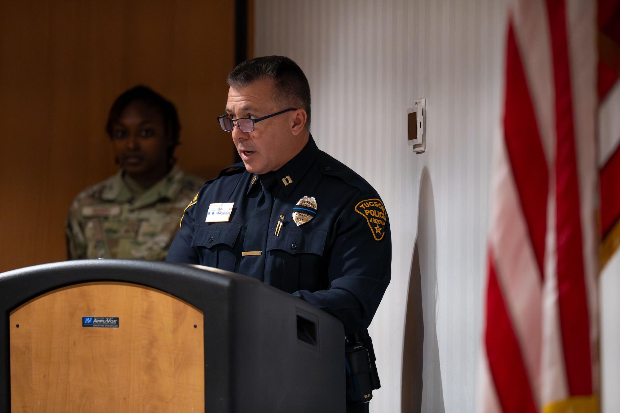 A member of the Tucson Police Department reads the names of officers killed in the line of duty since TPD’s creation at Davis-Monthan Air Force Base, Arizona, May 16, 2025. The 355th Security Forces Squadron, TPD and Customs and Border Protection participated in a Final Guard Mount ceremony to close out National Police Week. (U.S. Air Force photo by Senior Airman Jasmyne Bridgers-Matos)