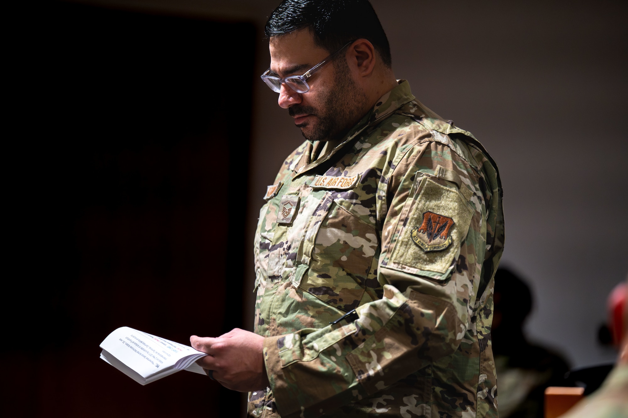 U.S. Air Force Master Sgt. Edwin Rodriguez, 355th Security Forces Squadron flight chief, performs roll call during a Final Guard Mount ceremony at Davis-Monthan Air Force Base, Arizona, May 16, 2025. Rodriguez read the names of fallen Defenders and their stories were shared to honor their sacrifice. (U.S. Air Force photo by Senior Airman Jasmyne Bridgers-Matos)