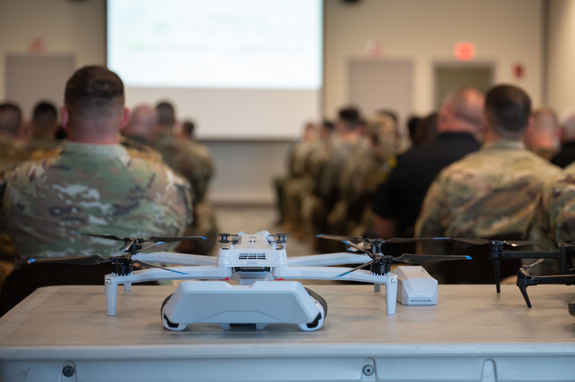 A classroom of military and civilian first responders in a class regarding drone response.