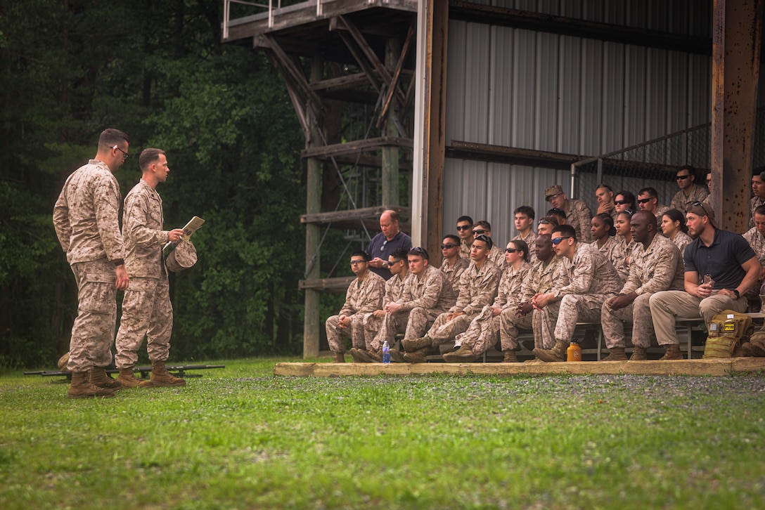 U.S. Marine Corps Staff Sgt. Robert Filardi III, an expeditionary firefighting and rescue specialist with Marine Corps Air Facility Quantico, left, briefs Marines with MCAF on order of operations prior to an M240B machine-gun range at The Basic School on Marine Corps Base Quantico, May 15, 2025. Marines with MCAF embarked on a two-day field exercise including events such as land navigation, a mess night, a machine-gun range and culminating with a field exfiltration. (U.S. Marine Corps photo by Lance Cpl. Braydon Rogers)