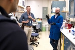 During a breakout chemistry lab tour at Innovation Day for Industry at the U.S. Naval Research Laboratory headquarters on May 7, 2025, Materials Engineer Gordon Waller with the NRL Chemistry Division talks with industry representatives about advanced battery safety technologies. Taylor Brownlie (left) said his company partners with NRL and came to Innovation Day to learn more about ways to collaborate. (U.S. Navy photo by Sarah Peterson)