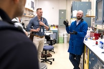 During a breakout chemistry lab tour at Innovation Day for Industry at the U.S. Naval Research Laboratory headquarters on May 7, 2025, Materials Engineer Gordon Waller with the NRL Chemistry Division talks with industry representatives about advanced battery safety technologies. Taylor Brownlie (left) said his company partners with NRL and came to Innovation Day to learn more about ways to collaborate. (U.S. Navy photo by Sarah Peterson)