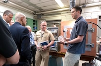 During a breakout chemistry lab tour at Innovation Day for Industry at the U.S. Naval Research Laboratory headquarters on May 7, 2025, Andrew Koehler with NRL High Electronics Science and Technology Division talks with NRL Commanding Officer Capt. Jesse Black and several industry representatives. (U.S. Navy photo by Sarah Peterson)