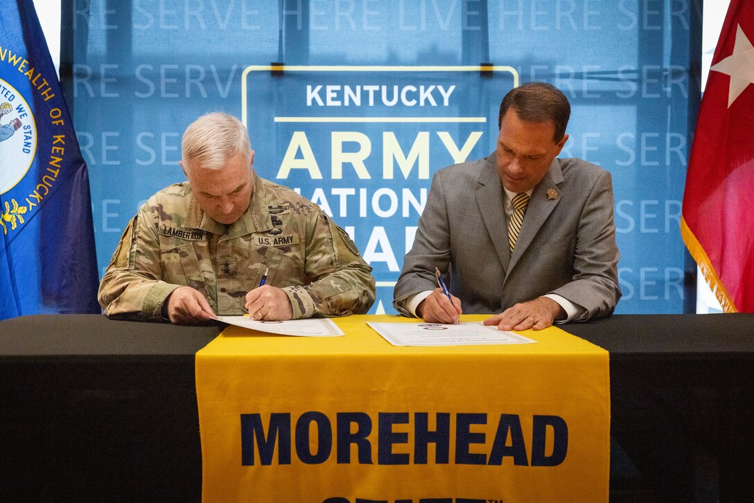 U.S. Army Maj. Gen. Haldane Lamberton (left), Kentucky’s adjutant general, and Dr. Jay Morgan, president of Morehead State University (MSU) signs the memorandum of understanding (MOU) between MSU and KYNG at MSU in Morehead, Ky. on May 5, 2025. KYNG and MSU signed the MOU to give more educational benefits to Soldiers and Airmen of the KYNG. (U.S. Army National Guard photo by Andy Dickson)