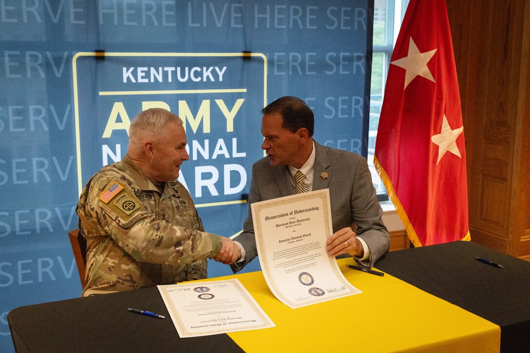 U.S. Army Maj. Gen. Haldane Lamberton (left), Kentucky’s adjutant general, and Dr. Jay Morgan, president of Morehead State University (MSU) shakes hands after signing the memorandum of understanding (MOU) between MSU and KYNG at MSU in Morehead, Ky. on May 5, 2025. KYNG and MSU signed the MOU to give more educational benefits to Soldiers and Airmen of the KYNG. (U.S. Army National Guard photo by Andy Dickson)